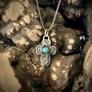 Sterling silver cross necklace with turquoise stone.