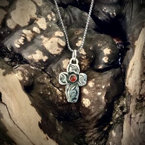 Sterling silver cross necklace with a faceted Garnet